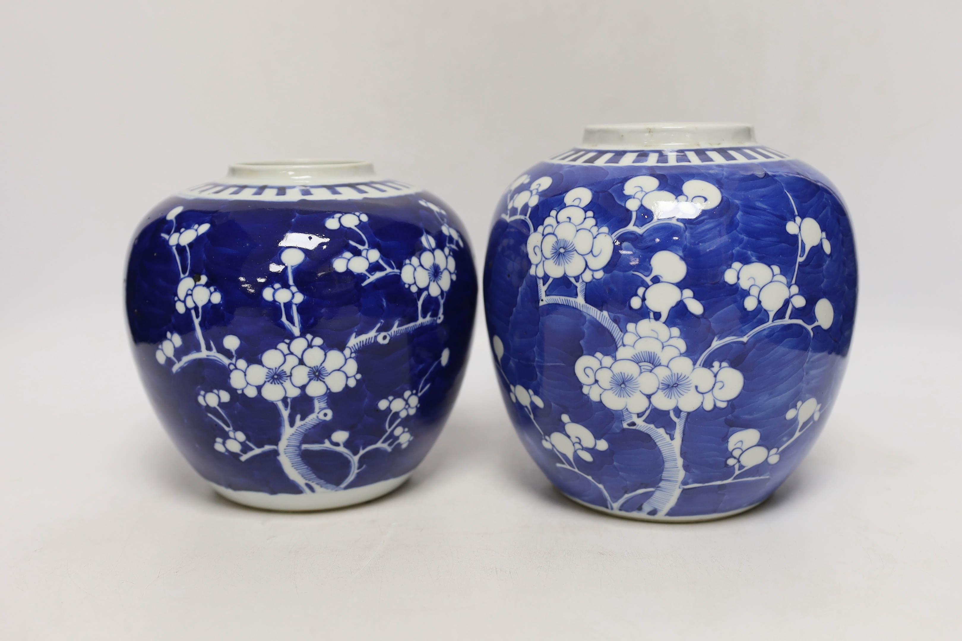 Two Chinese blue and white prunus jars, and a famille verte powder blue bowl, late 19th/early 20th century, tallest 17.5cm